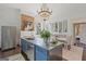 Eat-in kitchen with stainless steel island and brick accent wall at 3115 Pennington Sw St, Covington, GA 30014