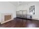 Living room with wood burning fireplace and dark hardwood floors at 3115 Pennington Sw St, Covington, GA 30014