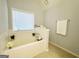 Bathroom featuring garden tub and window at 7665 Antebellum Ln, Riverdale, GA 30274