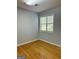 Bright bedroom with hardwood floors and large window at 7665 Antebellum Ln, Riverdale, GA 30274