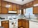 Kitchen with granite countertops and wood cabinets at 7665 Antebellum Ln, Riverdale, GA 30274