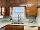 Kitchen sink and countertop detail with wood cabinets at 7665 Antebellum Ln, Riverdale, GA 30274