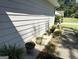 Landscaped side yard with potted plants and walkway at 7665 Antebellum Ln, Riverdale, GA 30274