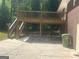 Exterior featuring a wooden deck, concrete patio, and brick siding at 2362 Maxwell Dr, Atlanta, GA 30311