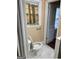 Bathroom featuring a toilet and sink, with marble floors at 2362 Maxwell Dr, Atlanta, GA 30311