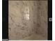 Bathroom with marble tile features a bathtub and shower with brushed metal fixtures at 2362 Maxwell Dr, Atlanta, GA 30311