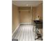 Clean laundry room with stainless steel sink, industrial shelving, and vinyl flooring at 2362 Maxwell Dr, Atlanta, GA 30311