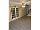 Spacious living room features vinyl flooring, a ceiling fan, and glass sliding barn doors at 2362 Maxwell Dr, Atlanta, GA 30311