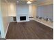 Inviting living room featuring hardwood floors, a fireplace, and a large window at 2362 Maxwell Dr, Atlanta, GA 30311