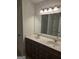 Double vanity bathroom with dark wood cabinets and marble countertop at 212 Himalaya Way, Mcdonough, GA 30253