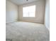 Spacious bedroom with neutral carpeting and large window at 212 Himalaya Way, Mcdonough, GA 30253