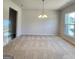 Bright dining room with chandelier and window at 212 Himalaya Way, Mcdonough, GA 30253