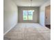 Bright dining room features a large window and stylish chandelier at 212 Himalaya Way, Mcdonough, GA 30253