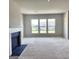 Bright living room with fireplace and large windows at 212 Himalaya Way, Mcdonough, GA 30253