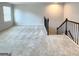 Spacious loft area with neutral carpet and staircase at 212 Himalaya Way, Mcdonough, GA 30253