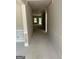 Unfinished hallway with a high ceiling and walls ready to paint at 115 Yancey Rd, Covington, GA 30014