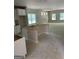 Open-concept kitchen featuring white cabinets at 115 Yancey Rd, Covington, GA 30014