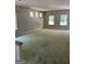 Large living room featuring large windows and walls ready to be painted at 115 Yancey Rd, Covington, GA 30014