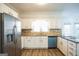 White kitchen with stainless steel appliances and granite counters at 13 Forest Ridge Ct, Sandy Springs, GA 30350