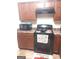 Kitchen with black appliances and brown cabinets at 6258 Ellenwood Dr, Rex, GA 30273