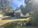Yellow ranch home with a covered porch and grill at 3449 Highway 138 Ne, Conyers, GA 30013