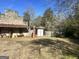 Rustic stone building with gas pump and outbuildings at 3449 Highway 138 Ne, Conyers, GA 30013