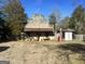 Rustic stone building with gas pump and outbuildings at 3449 Highway 138 Ne, Conyers, GA 30013
