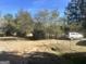 Large backyard with trees and a wooden fence at 3449 Highway 138 Ne, Conyers, GA 30013