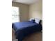 Bedroom with navy blue bedding and window with blinds at 6022 Centennial Run, Atlanta, GA 30349