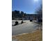 Gated community entrance with curved driveway and landscaping at 6022 Centennial Run, Atlanta, GA 30349