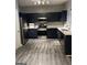 Modern kitchen with dark blue cabinets, stainless steel appliances, and white countertops at 6022 Centennial Run, Atlanta, GA 30349