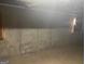Unfinished basement with concrete walls and flooring at 216 Rivers Rd, Fayetteville, GA 30214