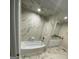 Modern bathroom with marble tile and soaking tub at 216 Rivers Rd, Fayetteville, GA 30214