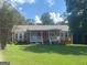 Ranch style home with a covered porch and a spacious yard at 216 Rivers Rd, Fayetteville, GA 30214