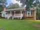 Ranch style home with large front porch and expansive lawn at 216 Rivers Rd, Fayetteville, GA 30214