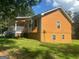 Side view of a ranch home showcasing its orange siding at 216 Rivers Rd, Fayetteville, GA 30214