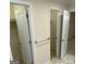Hallway with two closets and tile flooring at 216 Rivers Rd, Fayetteville, GA 30214