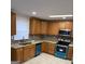 Updated kitchen with wood cabinets, granite counters, and teal appliances at 216 Rivers Rd, Fayetteville, GA 30214