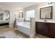 Spa-like bathroom with double sinks, garden tub, and view of bedroom at 801 Carnegie Ct, Locust Grove, GA 30248