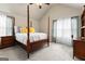 Spacious bedroom with wood post bed, ample natural light, and carpet flooring at 801 Carnegie Ct, Locust Grove, GA 30248