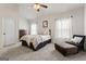 Bright bedroom with a comfy bed and sitting area at 801 Carnegie Ct, Locust Grove, GA 30248