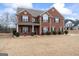 Brick two-story house with landscaping and a large front yard at 801 Carnegie Ct, Locust Grove, GA 30248