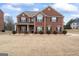 Two story brick home with landscaped yard at 801 Carnegie Ct, Locust Grove, GA 30248