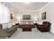 Bright living room with comfortable seating and hardwood floors at 801 Carnegie Ct, Locust Grove, GA 30248