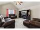 Relaxing living room with leather reclining furniture and large TV at 801 Carnegie Ct, Locust Grove, GA 30248
