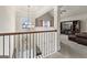 Open upper landing with chandelier, overlooking living room at 801 Carnegie Ct, Locust Grove, GA 30248