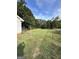 Fenced backyard with green grass and mature trees at 4755 Jersey Walnut Grove Rd Rd, Covington, GA 30014