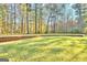 Spacious backyard with a retaining wall and lush green grass at 180 Wesley Forest Dr, Fayetteville, GA 30214