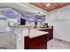 Basement wet bar with granite countertop and dark wood cabinets at 180 Wesley Forest Dr, Fayetteville, GA 30214