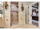 Elegant bathroom with a walk-in shower, tiled walls, and a view of the bedroom at 180 Wesley Forest Dr, Fayetteville, GA 30214